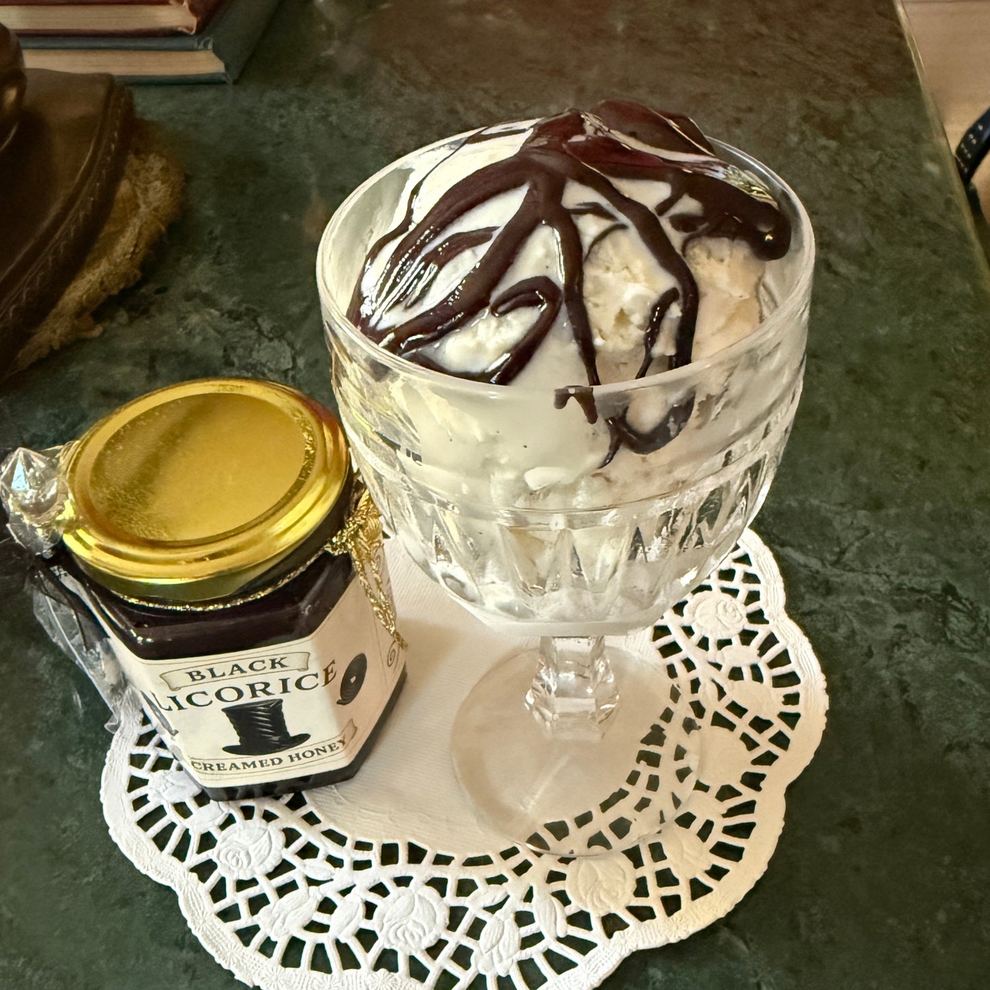 Creamy black licorice honey drizzled over vanilla ice cream—bold dessert topping idea.