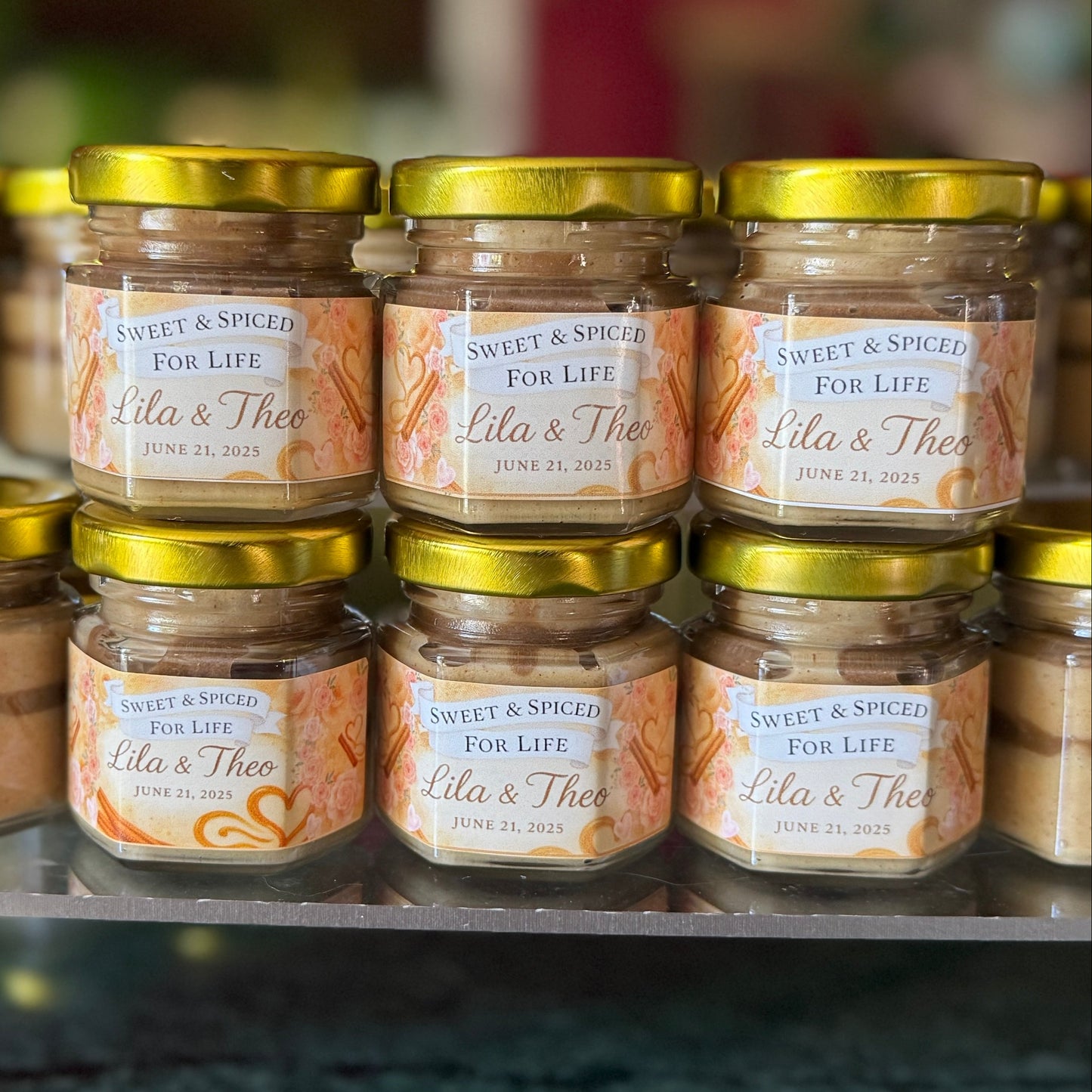 Personalized cinnamon creamed honey wedding favor in a mini glass jar with custom label, perfect for rustic or fall weddings.
