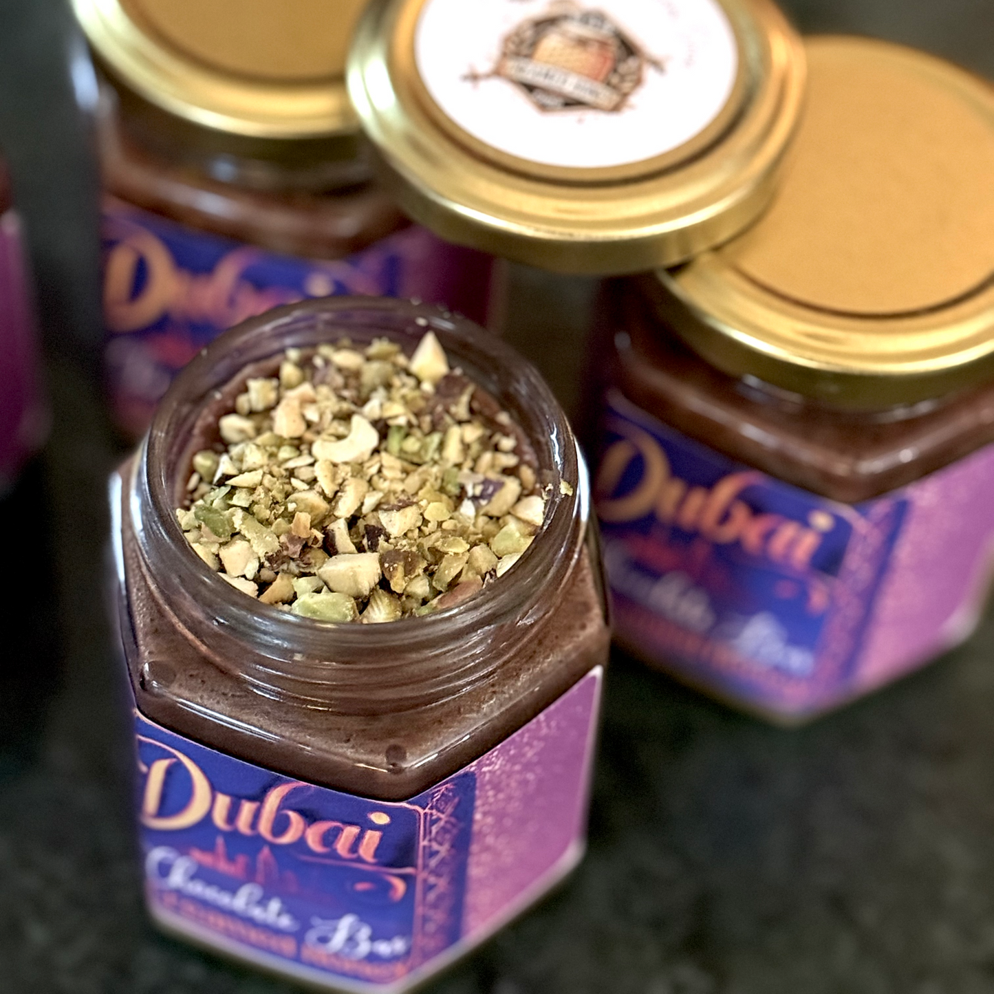 Velvety Dubai Chocolate Creamed Honey with a pistachio cream center and Nutella ganache topping, a luxurious spread for chocolate lovers