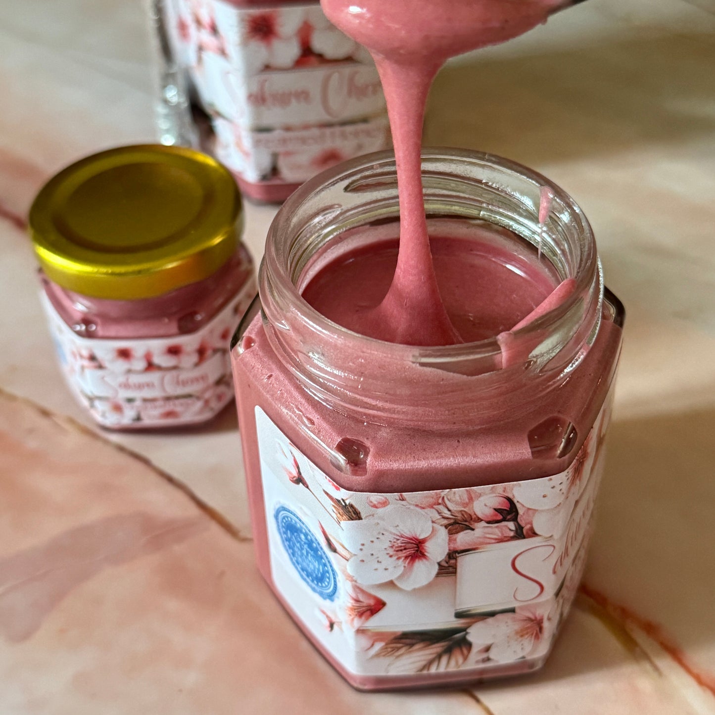 "Seasonal Sakura Cherry Creamed Honey, combining the rich flavor of cherry blossoms with smooth, creamy honey, perfect for spring-inspired treats."
