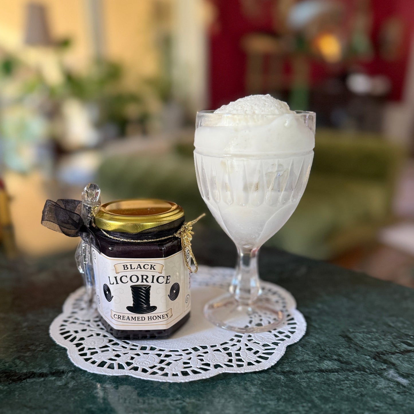 Black Licorice Creamed Honey styled beside desserts—perfect for gifting or creative topping ideas.