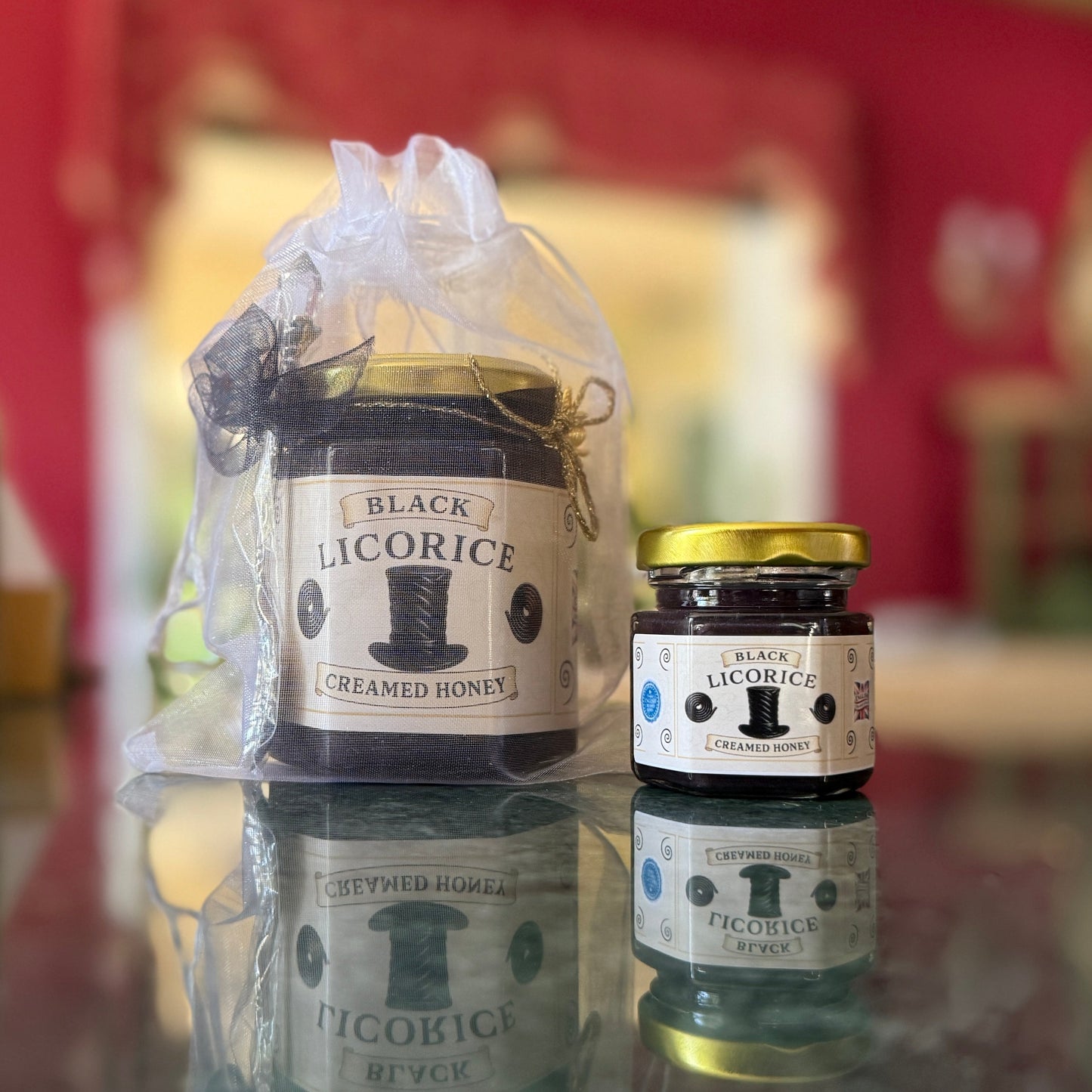 Black Licorice Creamed Honey in sheer organza gift bag with gold accents, ready to give.