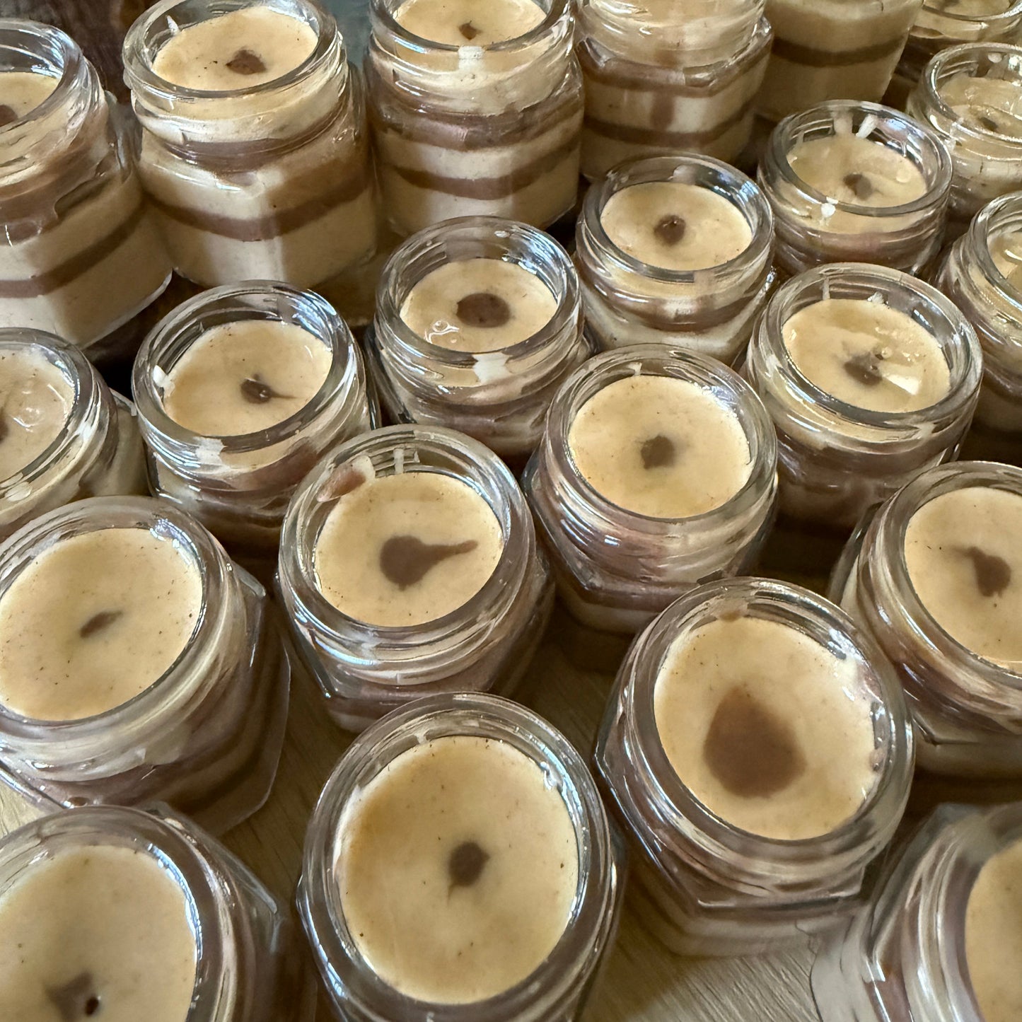 Rustic cinnamon creamed honey jars with heart-patterned custom labels, designed as thoughtful wedding guest favors