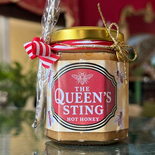Gift-ready hot honey in glass jar labeled The Queen’s Sting, perfect for foodies